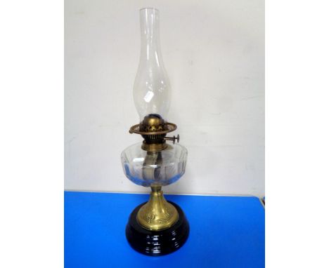A Victorian oil lamp with glass chimney. 