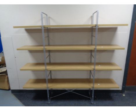 A contemporary four tier light oak effect shelf. 