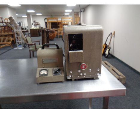 A vintage Bell and Howell model 601 movie projector with power supply. 