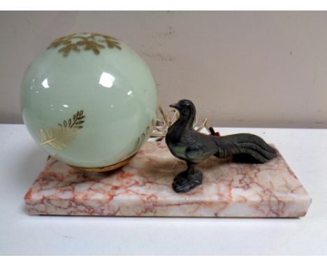 An Art Deco marble table lamp surmounted with a peacock 