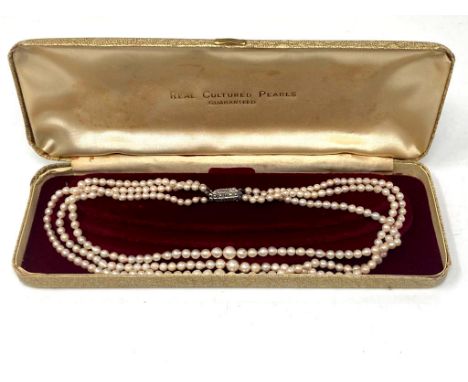 A three-row cultured pearl necklace 