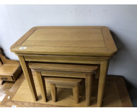 A nest of contemporary light oak tables. 