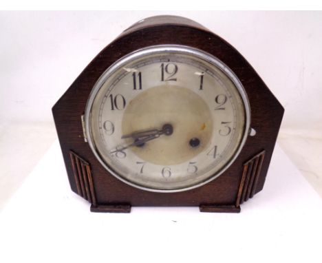 An Edwardian oak mantel clock. 