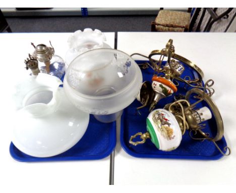 Two brass framed and ceramic ceiling lights together with two further glass paraffin lamp reservoirs and three glass shades. 