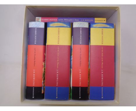 Five various Harry Potter volumes, one signed by J K Rowling 