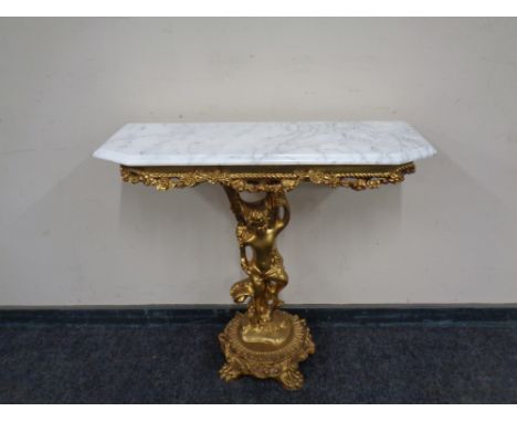 A marble topped gilded wooden console table.