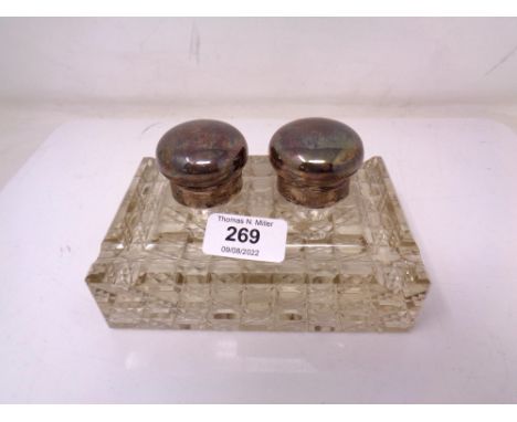 An early 20th century glass inkwell with silver mounts 