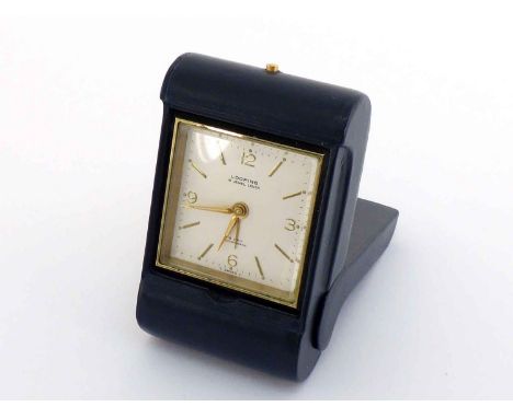 A Looping travelling alarm clock, the Swiss 15 jewel lever movement with baton hour marking, Arabic numerals at the quarters,