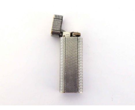 Cartier, a silver plated lighter, together with red suede pouch 