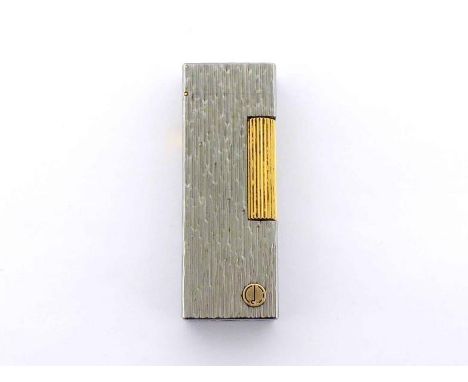 Dunhill. A stainless steel lighter, bark effect, with gilt metal detail, 6.4cm long 