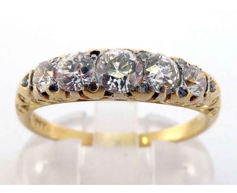 A diamond five stone ring, composed of five graduated old brilliant cuts, to a scroll gallery mount, the shank stamped '18c',