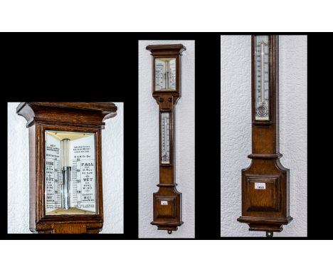 A Late Victorian Oak Stick Barometer makers Adie, Broadway Works, Westminster.  Large mercury tube above a barometer of squar