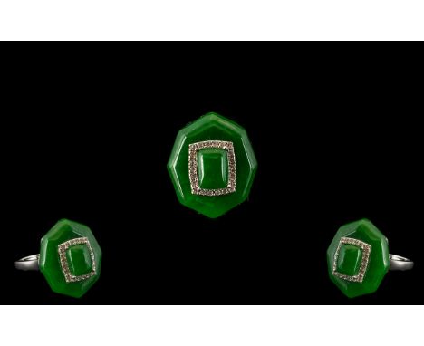 Jade Statement Ring, 24cts of green jade in the form of an elongated octagonal cushion, above a decorative gallery in rhodium
