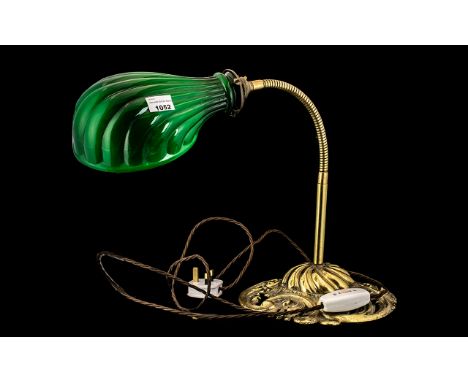 A Brass Mounted Expandable Arm student lamp with a green glass shade and a fancy brass cast base. 40 inches high. 