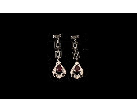 Pair of Ruby Art Deco Style Drop Earrings, an elegant pair of earrings with pear drop pendants, each set with a pear cut, blo