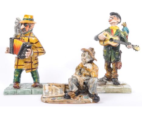 Three late 20th century Italian porcelain figurines in the manner of Capodimonte. Comprising of two male musician figurines m