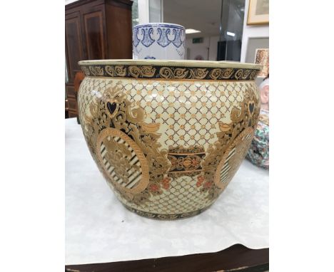 A large ceramic gilt fish bowl
