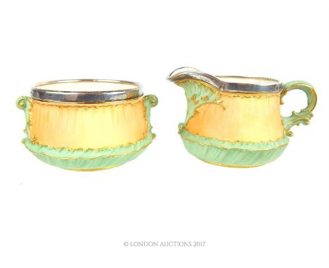 A matching Victorian Royal Worcester milk jug and sugar bowl, both with sterling silver rims, Birmingham 1886, with puce mark