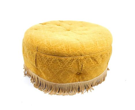 A circular pouffe upholstered in mustard fabric, 40 x 80 x 80 cm.