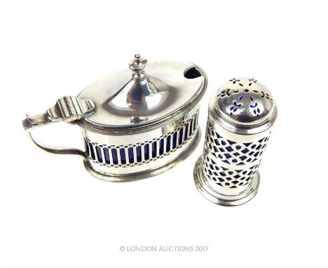 A hallmarked silver mustard, William Hutton & Sons, Chester 1914, of oval form with pierced sides, together with an Edwardian