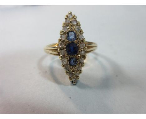 An Edwardian navette form sapphire and diamond ring, set in 18ct gold, with a vertical line of three graduated round cut sapp