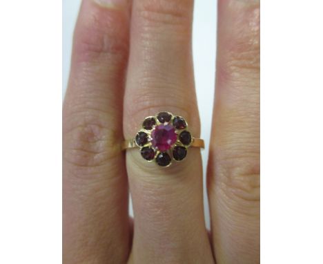 A ruby and red hardstone cluster ring, all set in yellow precious metal (marks worn, likely to high carat gold), size R, 3.8g