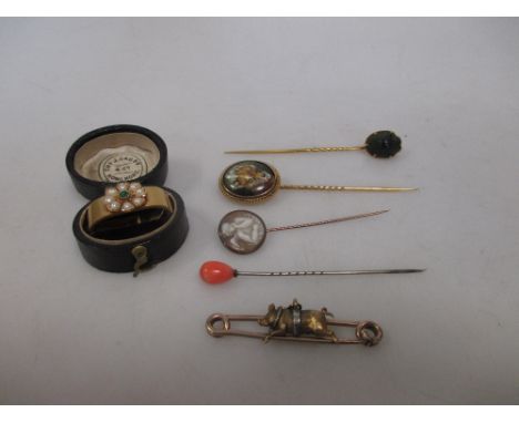 Four stick pins, a flying pig brooch and a scarf pin, cased  