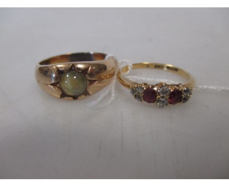 An 18ct ruby and diamond ring, size L and a cats eye chrysoberyl unmarked yellow precious metal ring (tests as approx. 14ct),