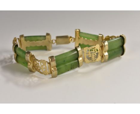 A Chinese spinach jade and gilt metal articulated bracelet, five fluted tablets divided by pierced panels, 21cm long 
