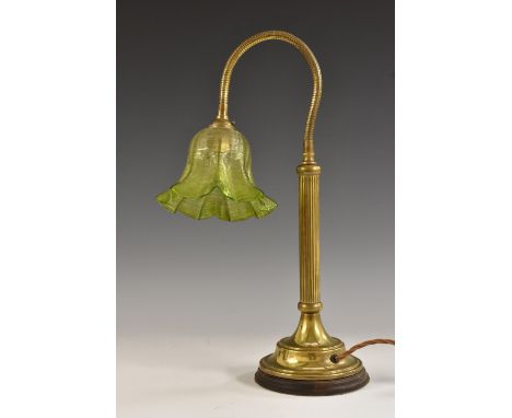 An Art Nouveau style lacquered brass angle-poise desk lamp, frilled green glass shade, fluted column, domed base, 39cm high