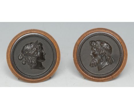 A pair of 19th century Grand Tour bois durci portrait medallions, after the antique, depicting Zeus and Hera, 6.5cm diam, c.1