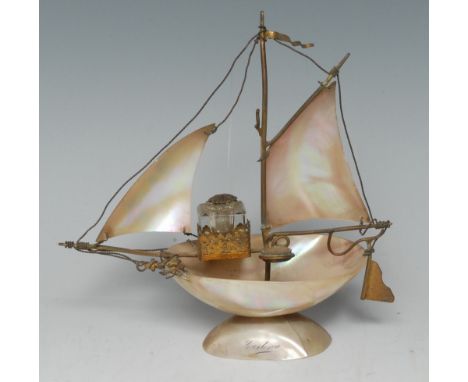 A 19th century souvenir mother of pearl novelty inkstand, as a sailing boat, mounted with a glass well and a compass, the bas