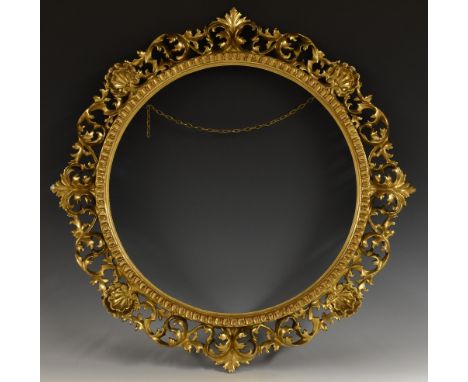 A 19th century Italian giltwood and gesso circular picture frame, carved in the typical Florentine manner with shells and scr