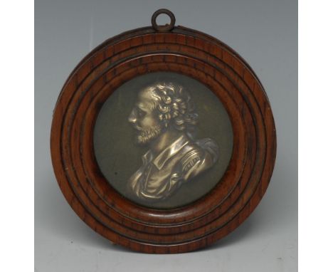 A 19th century brass portrait plaque, of William Shakespear, bust length in profile, 7cm diam, turned oak frame