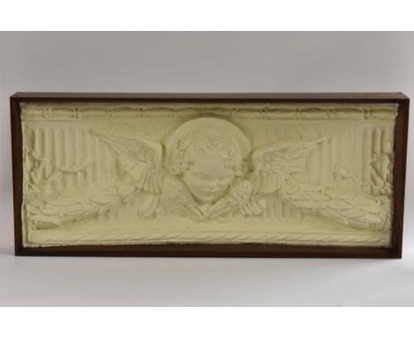 An architectural plaster cast, of a sectional frieze, cast in high relief and centred by a saintly putto's head, outstretched
