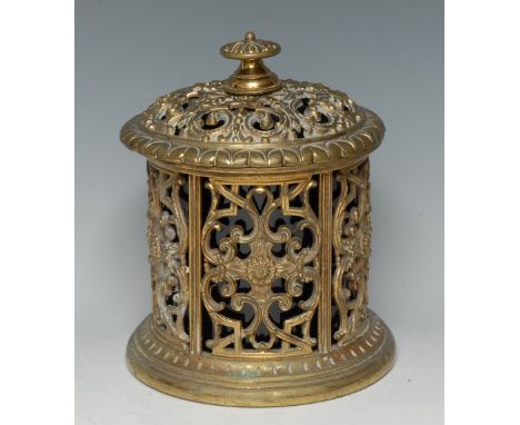 A 19th century gilt brass country house tobacco jar, pierced and cast throughout with scrolls and strapwork, ceramic liner wi
