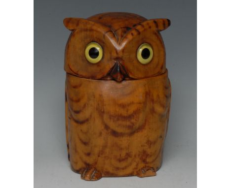 An early 20th century novelty tobacco jar or tea caddy, carved as an owl, pyrography feathers, hinged cover, glass eyes, 20cm