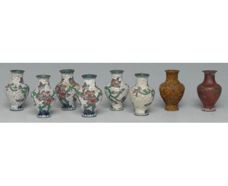 An interesting set of eight Chinese cloisonné enamel miniature vases, illustrating the stages of the process, 5cm high, 