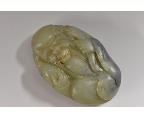 A Chinese jade snuff bottle, carved as a grinning Shou Lao, 8cm long