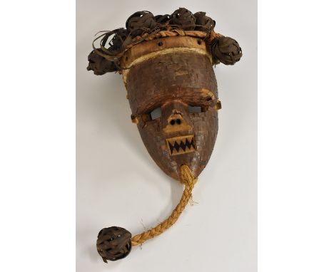 Tribal Art - a Salampasu mask, woven ball coiffure, the face applied with sheet copper lozenges, 43cm long, Congo region, Cen