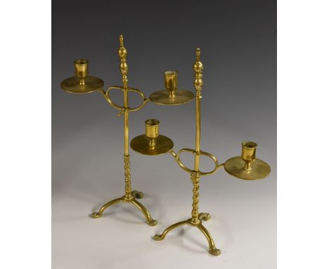 A pair of 19th century brass adjustable table candelabra, knop finials, waisted cylindrical sconces, broad drip pans, twisted