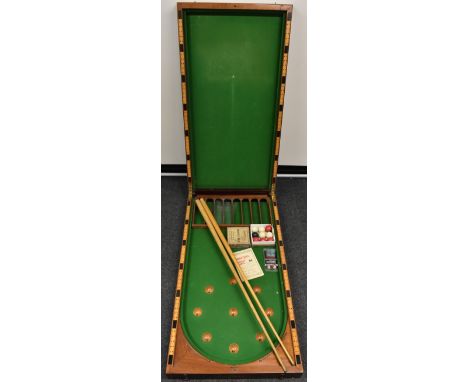 An Edwardian mahogany bagatelle table, by E.J. Riley, Accrington, 117cm long (folded), 56cm wide, c. 1910