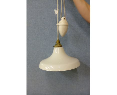 An opaque glass rise and fall ceiling light