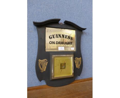 A reproduction Guinness advertising barometer