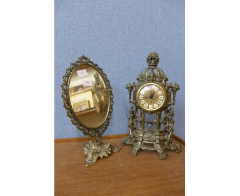 A brass plated mirror and clock