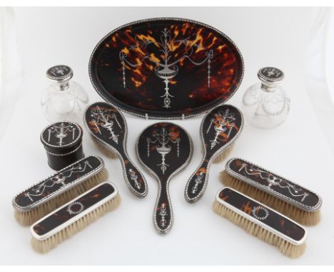 Tortoiseshell and silver dressing items including hand mirror, hair and clothes brushes pair of cut glass scent bottles 