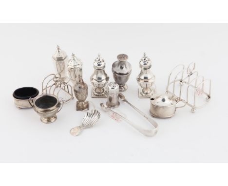 Various silver items, comprising 10 cruet items, shell caddy spoon, two small toast racks and a pair of tongs, weight of silv
