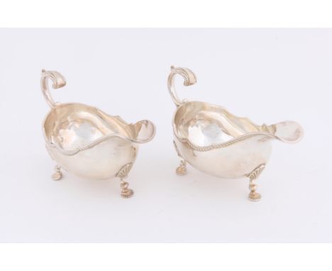 Pair of modern silver sauce boats by R and K London 1969, with gadrooned borders and scroll handles on shell feet, 17 cms, 16