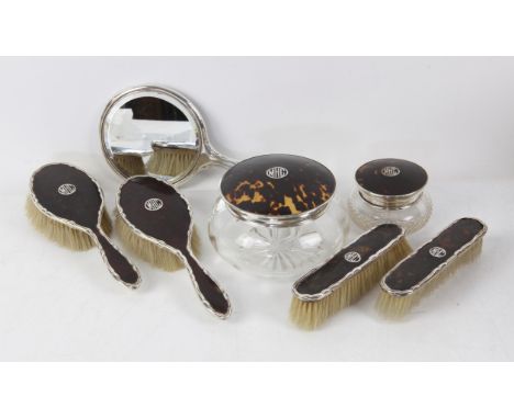 Silver and tortoiseshell dressing table set, each piece inset with the initials 'MHC', comprising a pair of brushes, a pair o