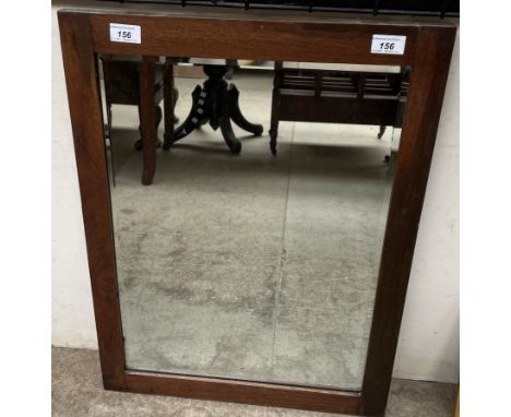 A rectangular framed wall mirror with a bevelled plate